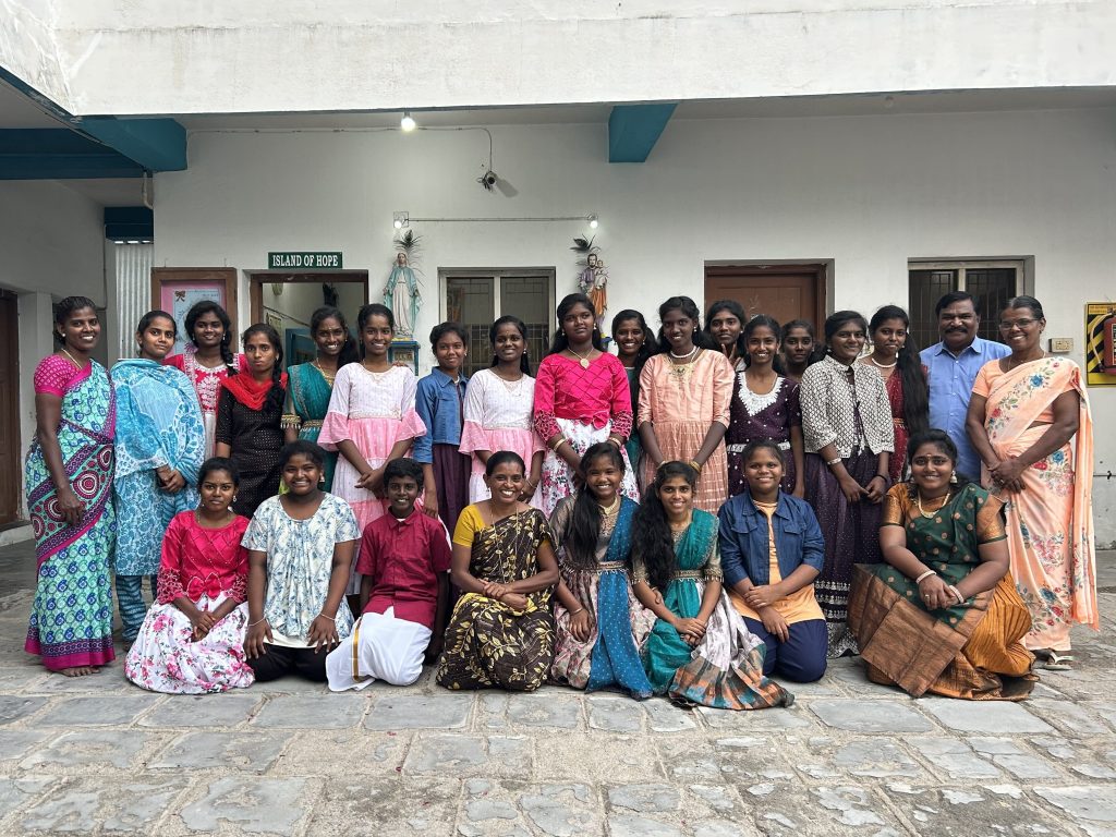 All children and women living in Island of Hope posing for a photo with General Secretary Peter Raj