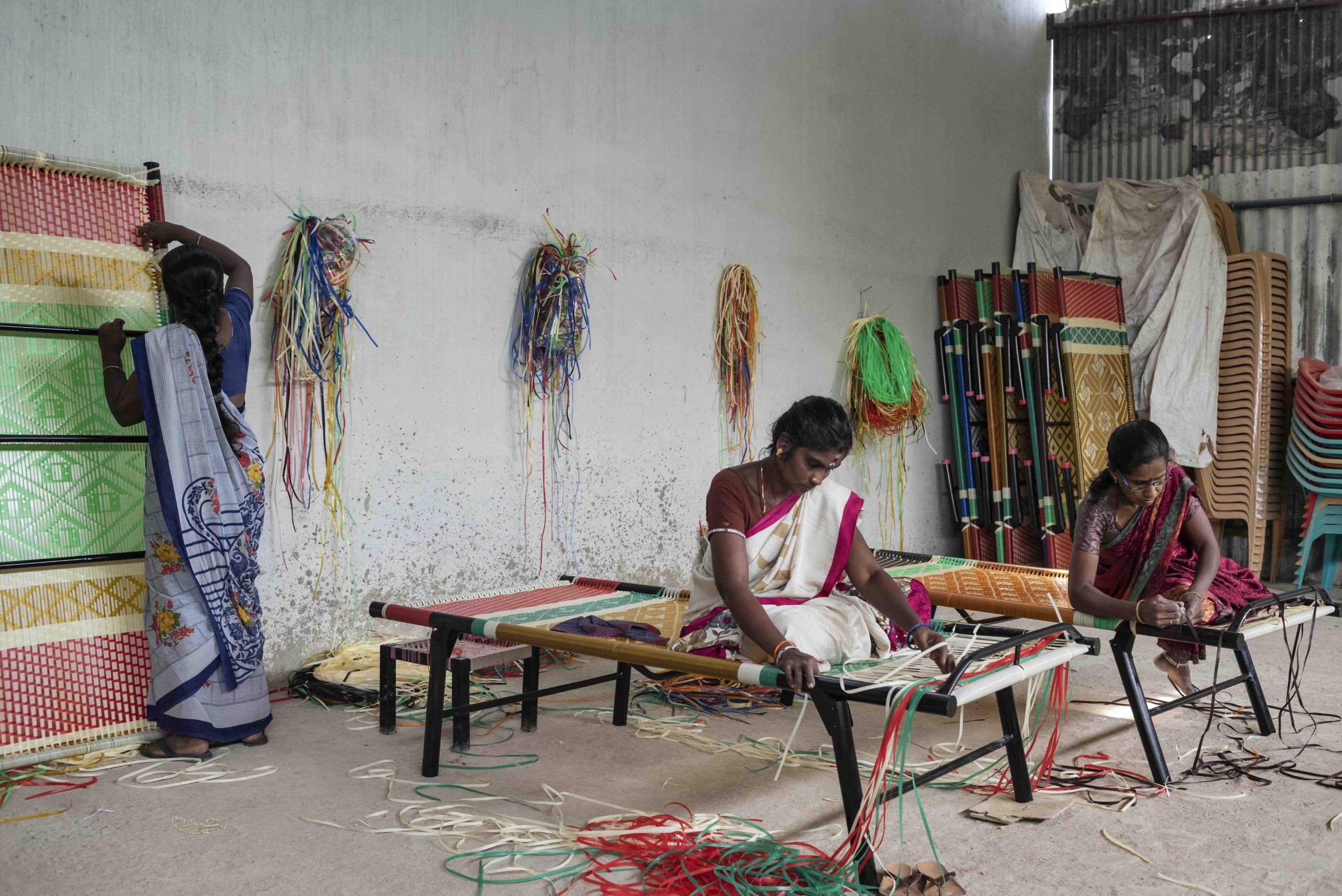 Carefully weaving the colorful threads of a traditional Indian bed