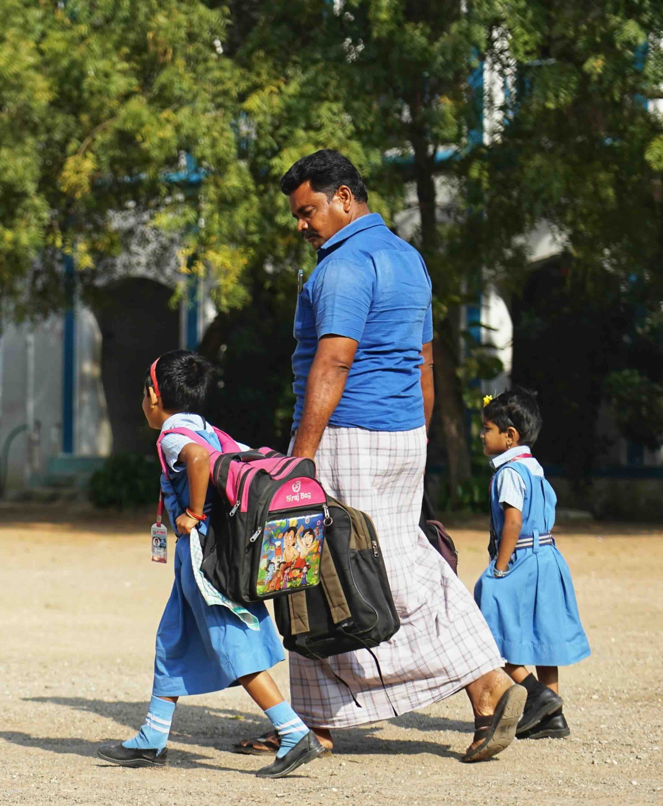 Father walking his two daughters to class
