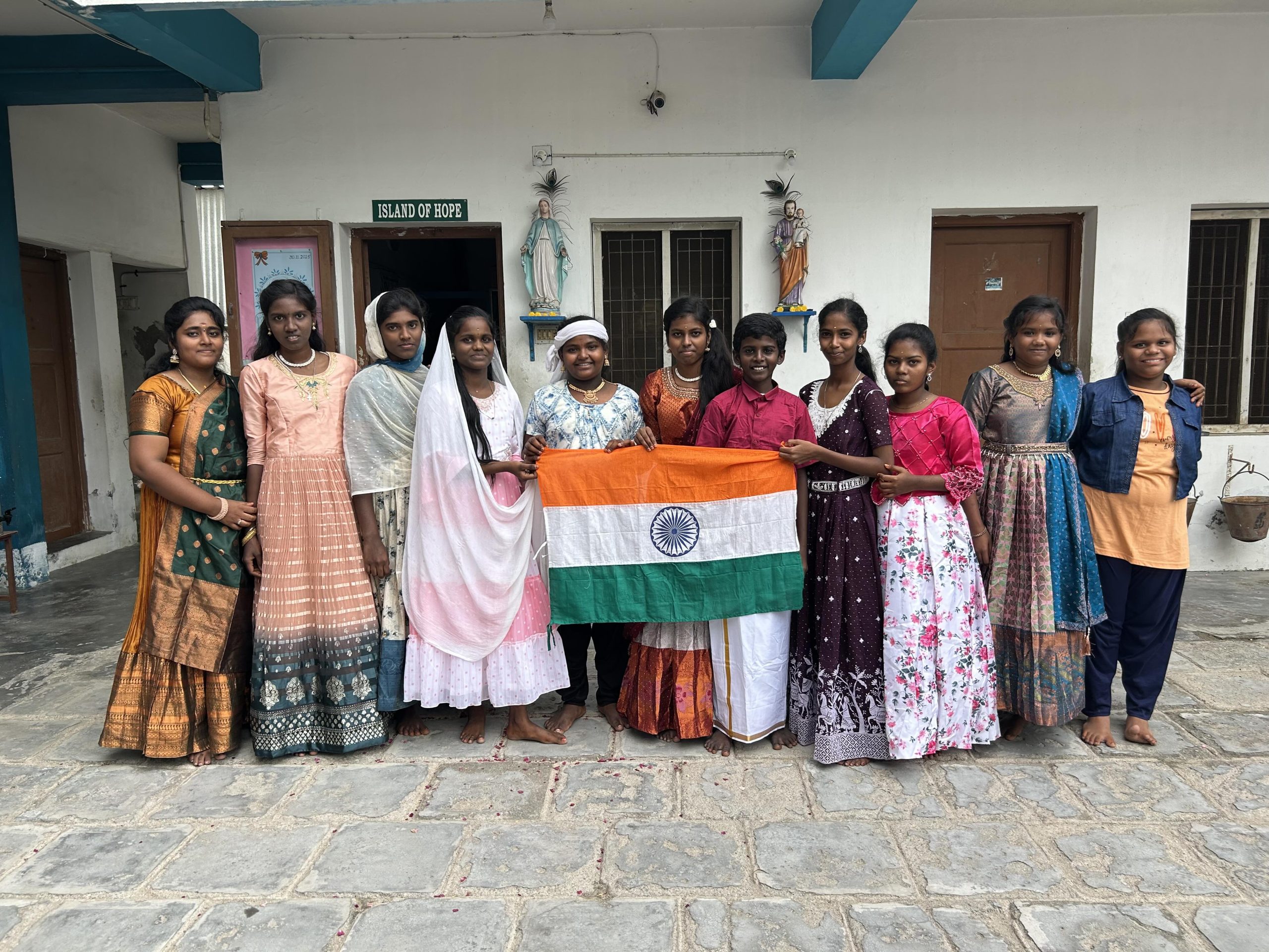 Island of Hope residents holding the Indian flag after a dance performance