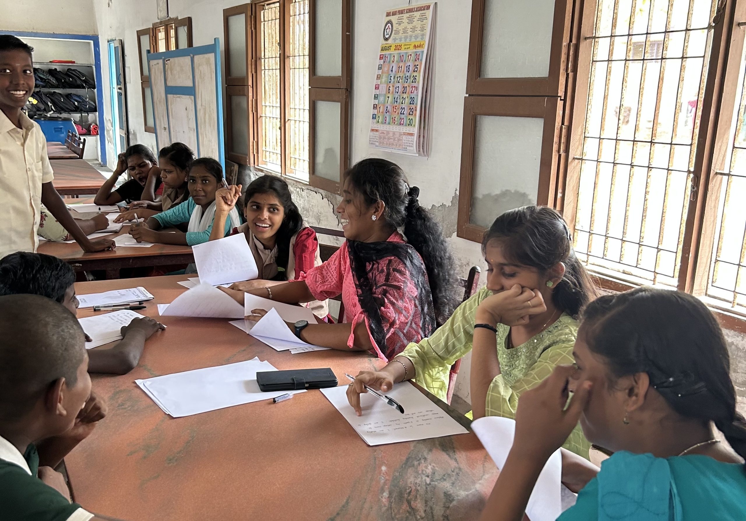 Orphanage residents writing a letter to their sponsors