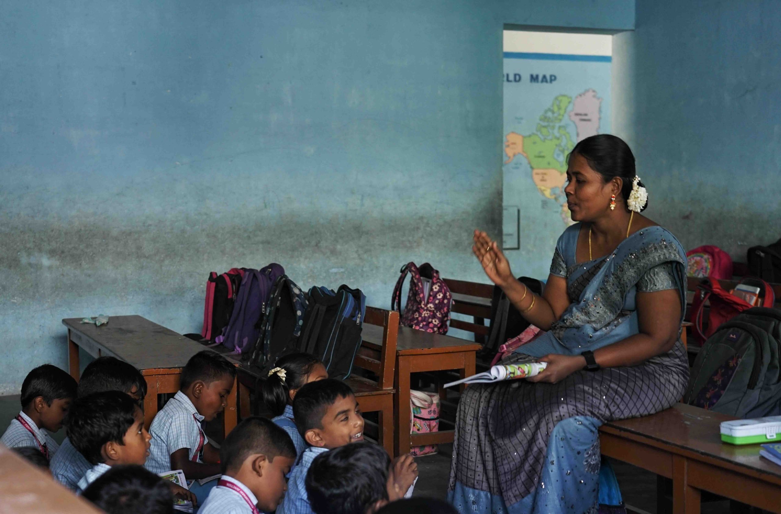 Primary student with their teacher during a Tamil class