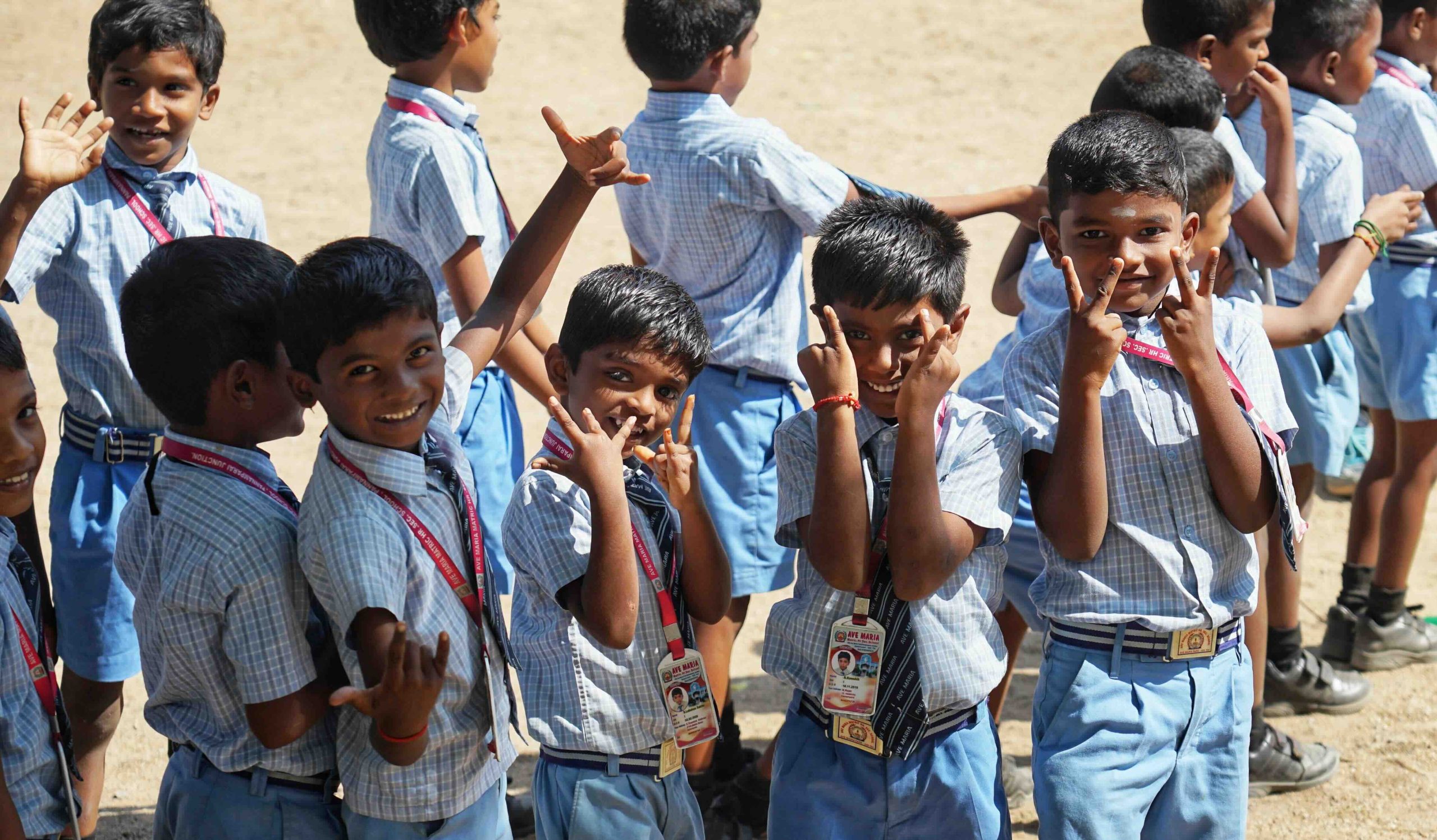 Primary students smiling at the camera