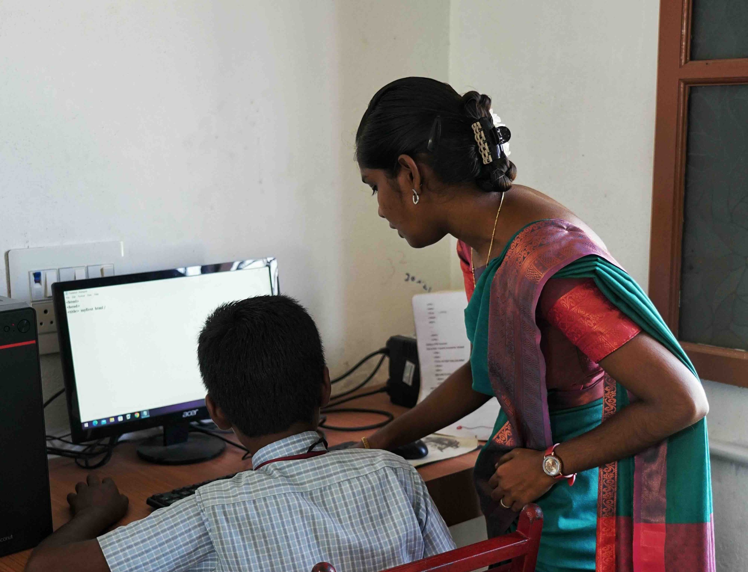 Student and teacher in the computer lab