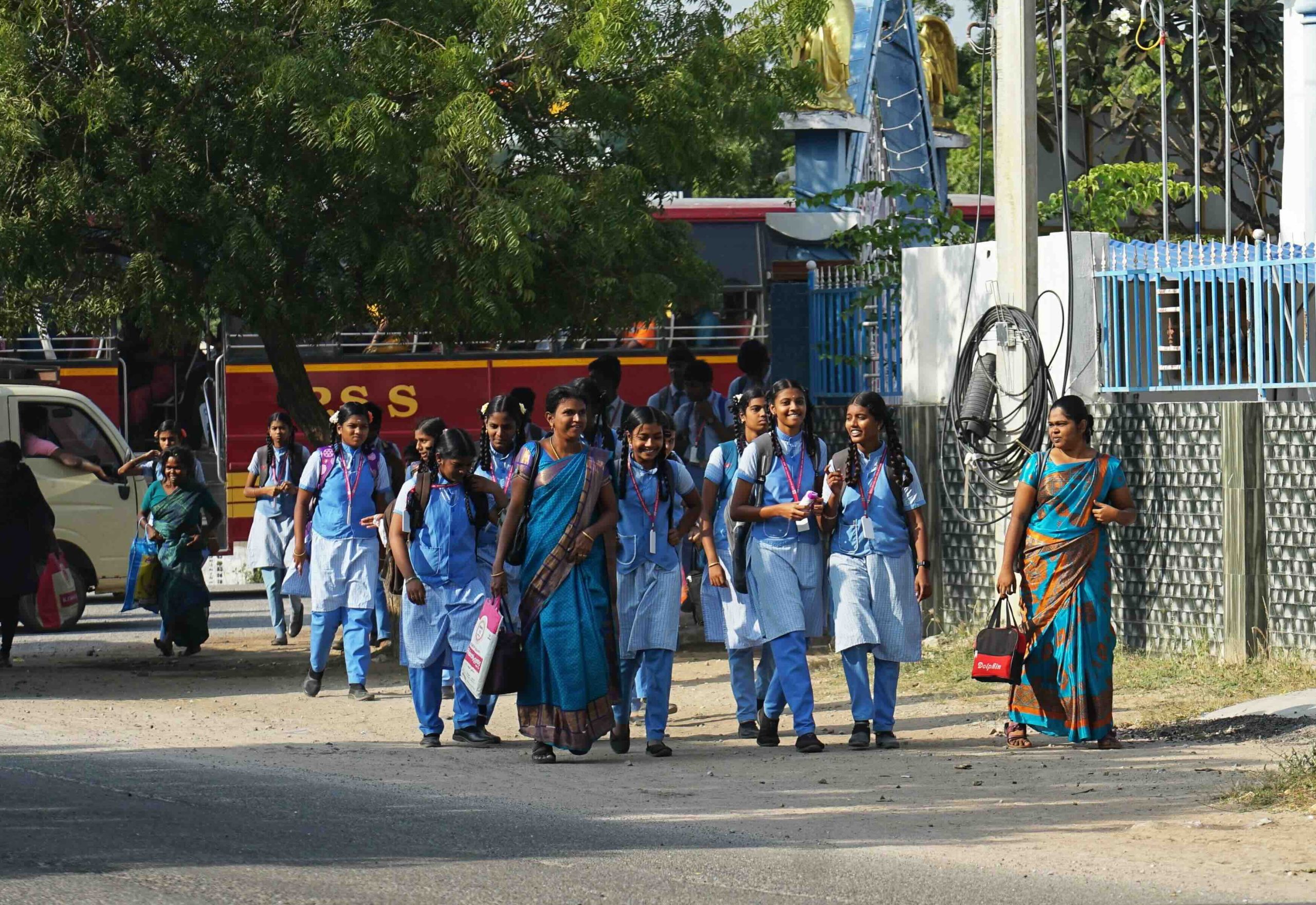 Students and teachers heading to school after taking the public bus
