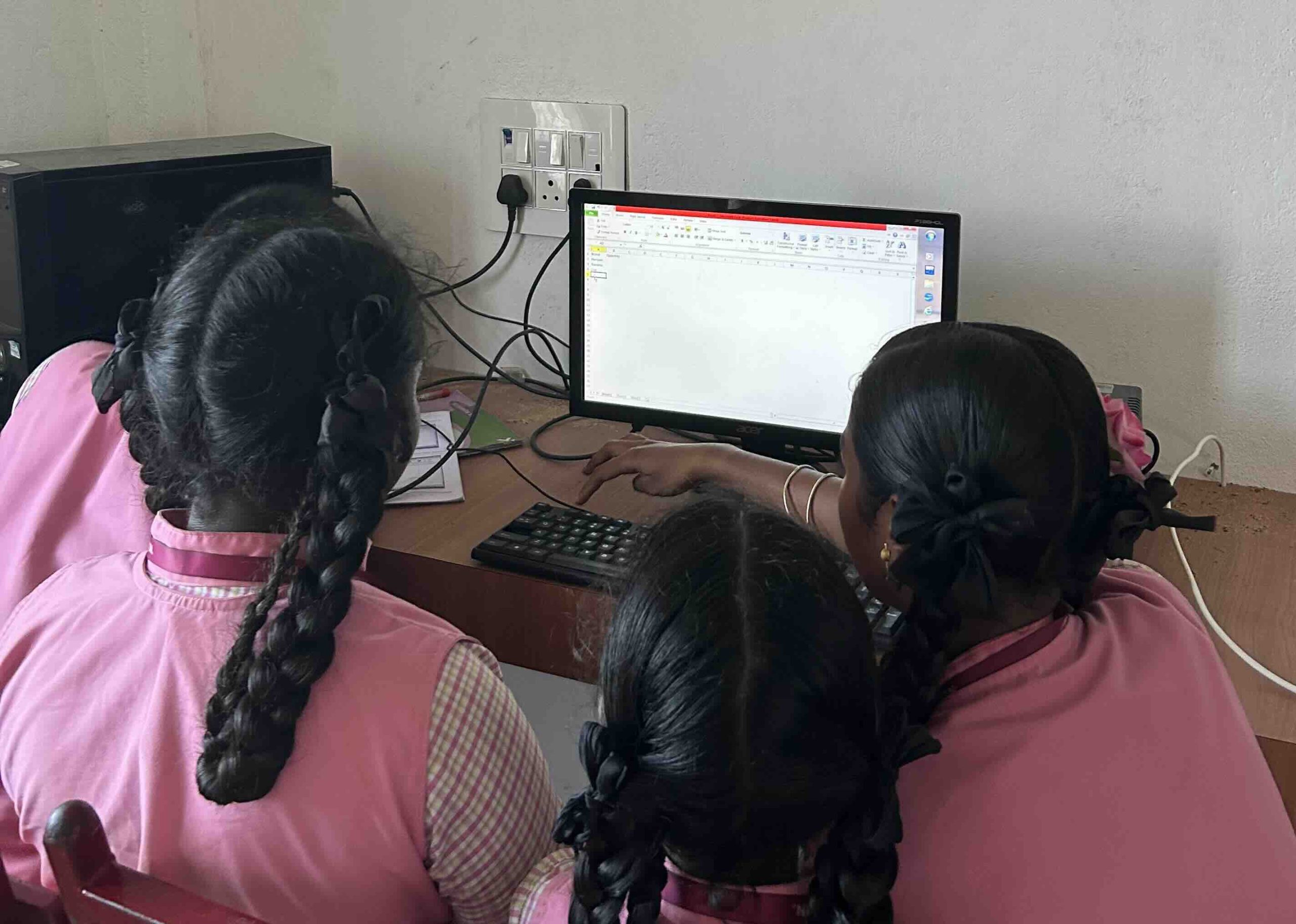 Students collaborating on a digital assignment in the school lab
