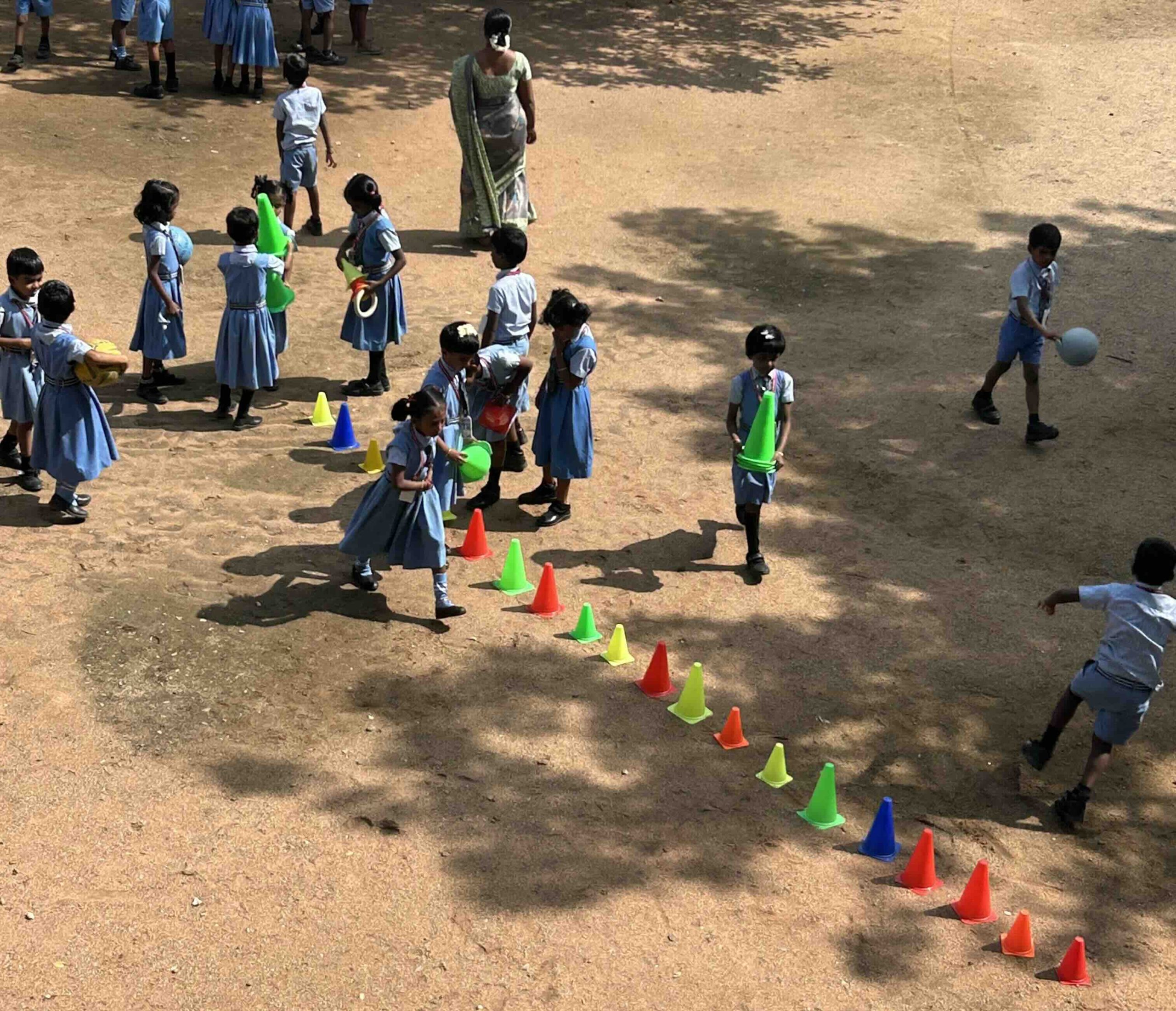 Students enjoying setting up a colorful obstacle course for playtime