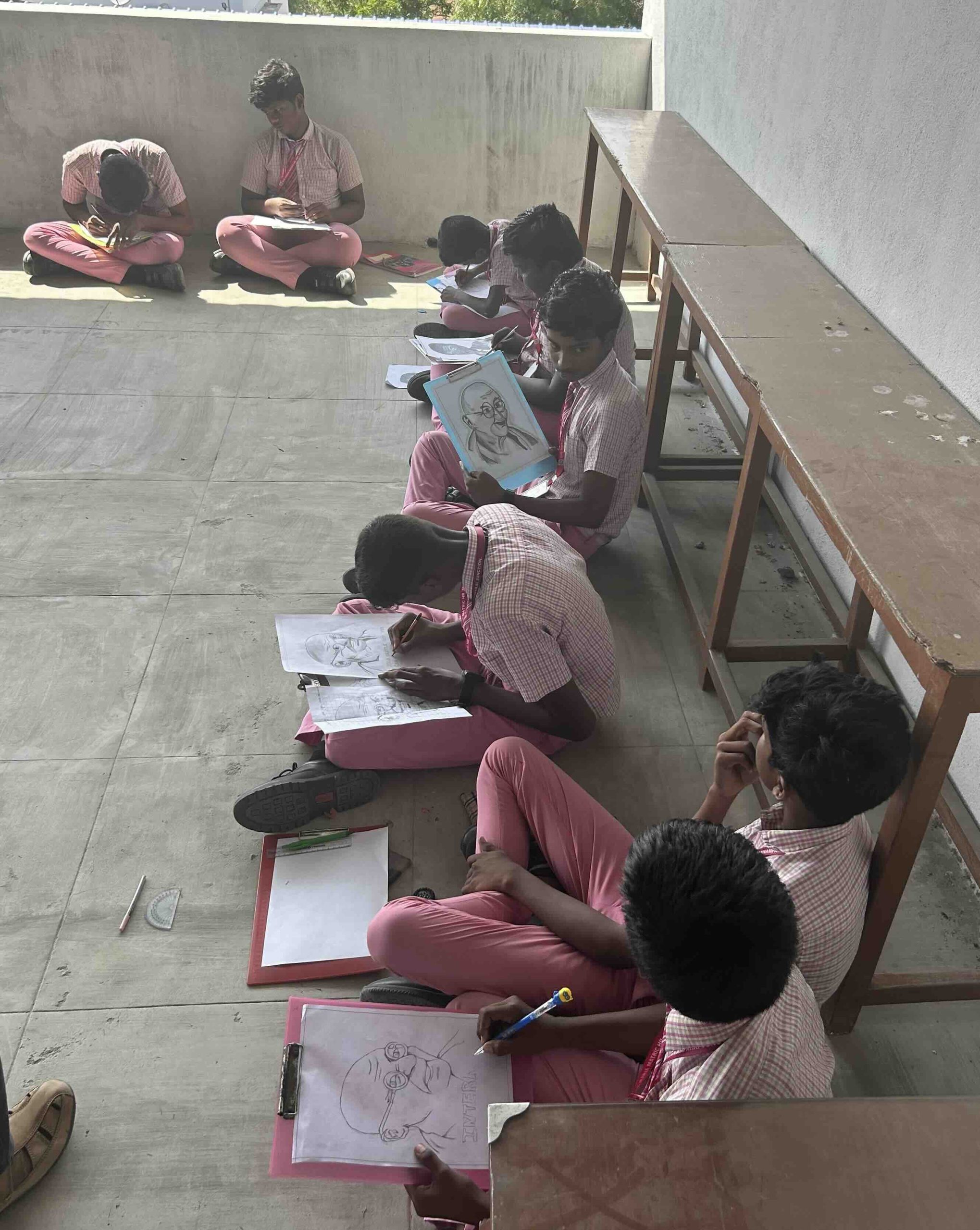 Students participating in a drawing competition during Non-Violence Day