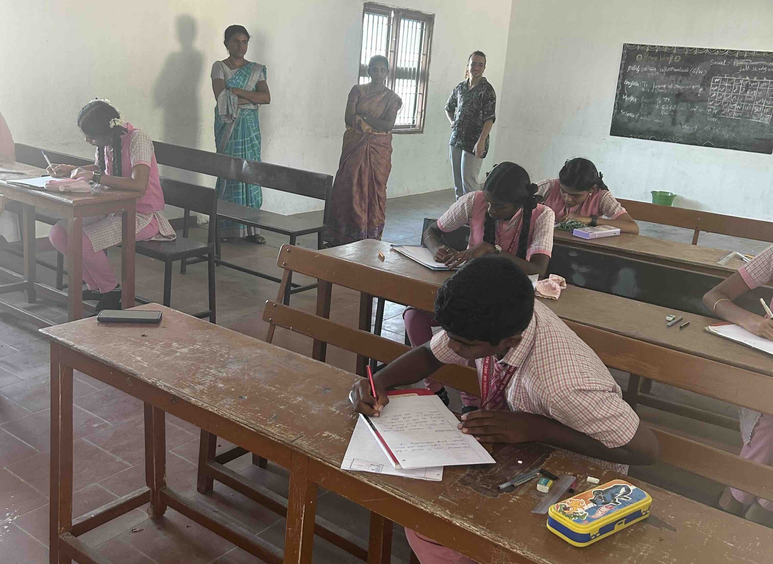 Students participating in a writing competition during Non-Violence Day