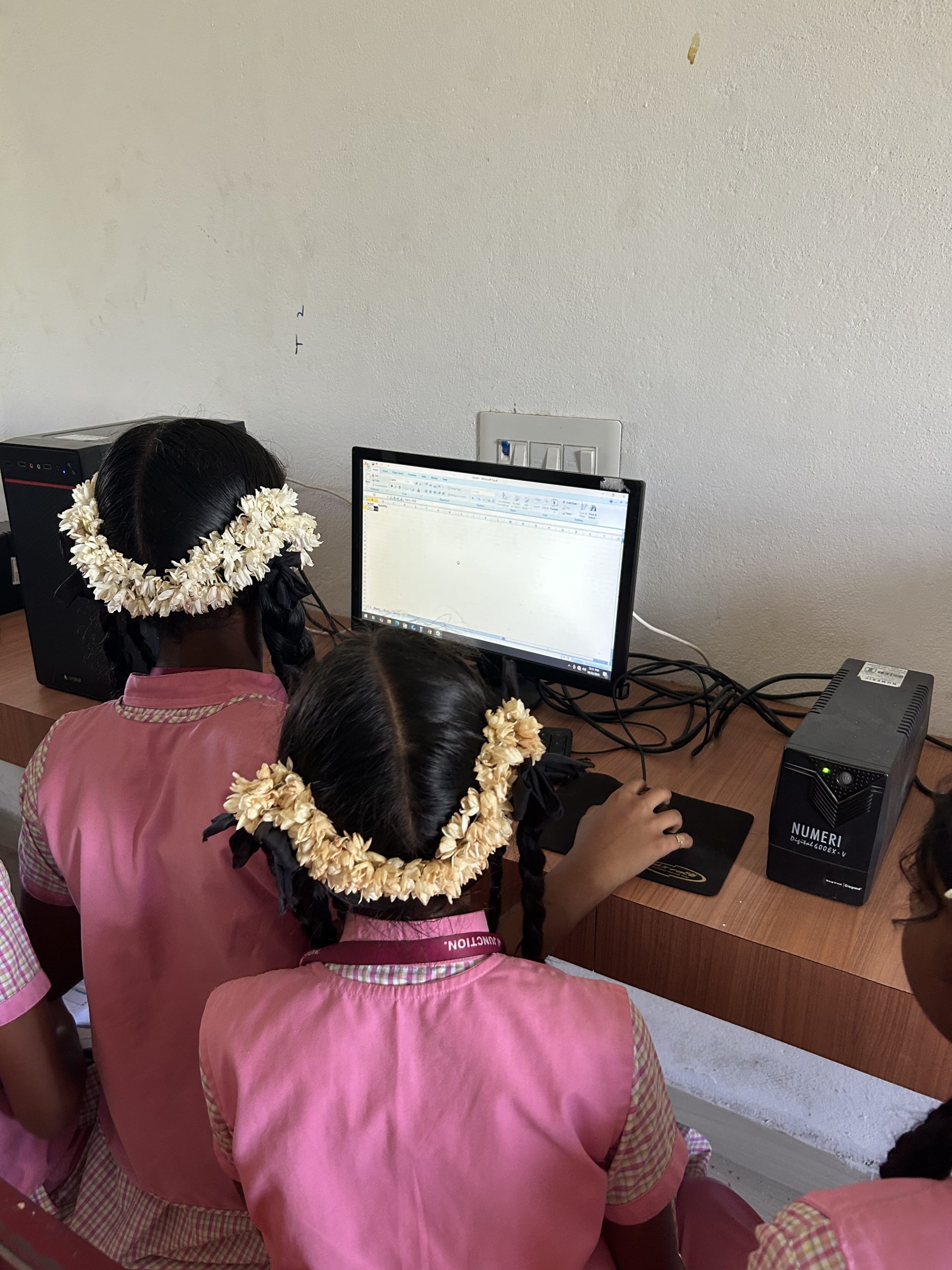 Students working together on a digital assignment in the school lab
