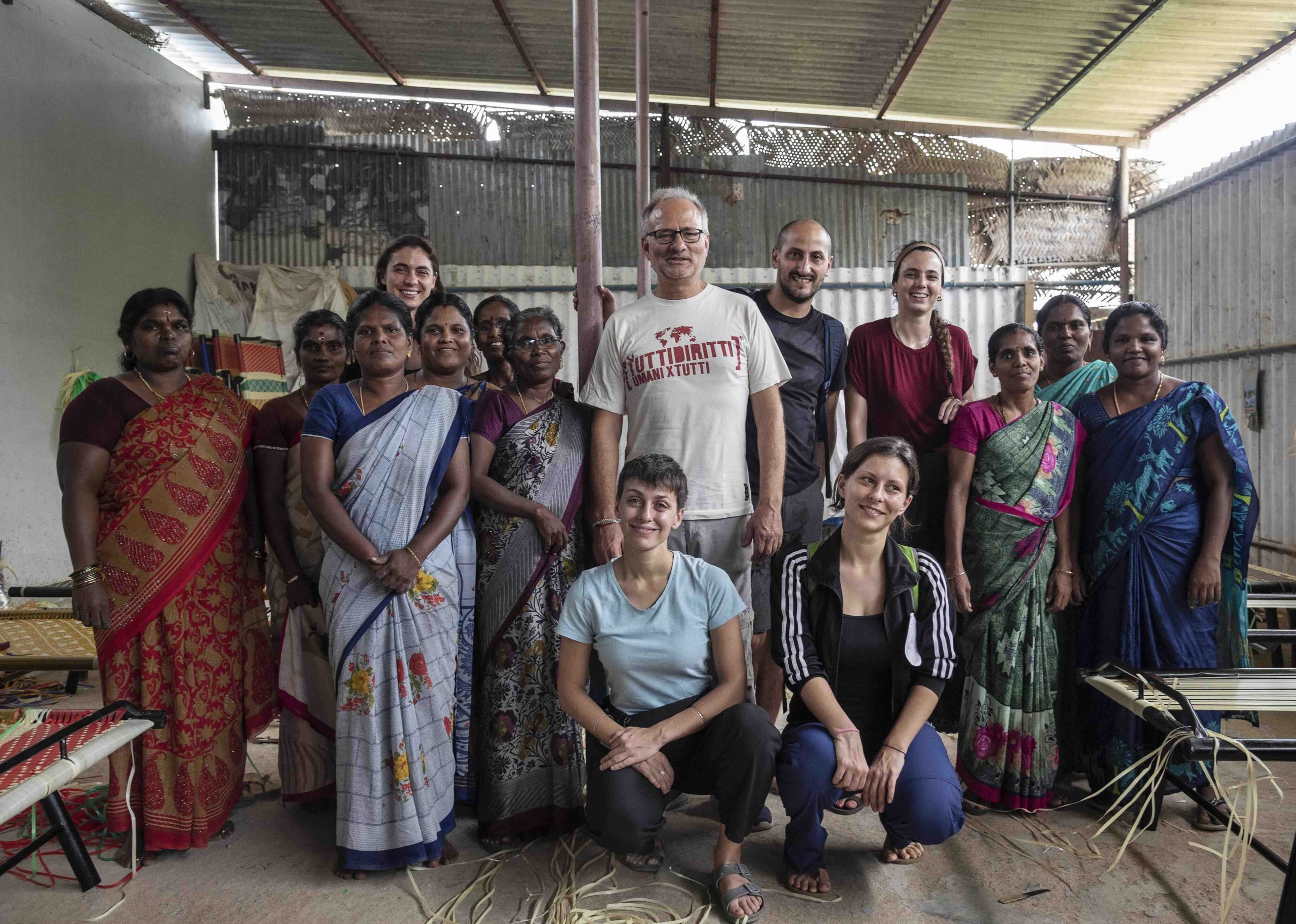 Women from the bed net factory posing for a photo with Energia volunteers
