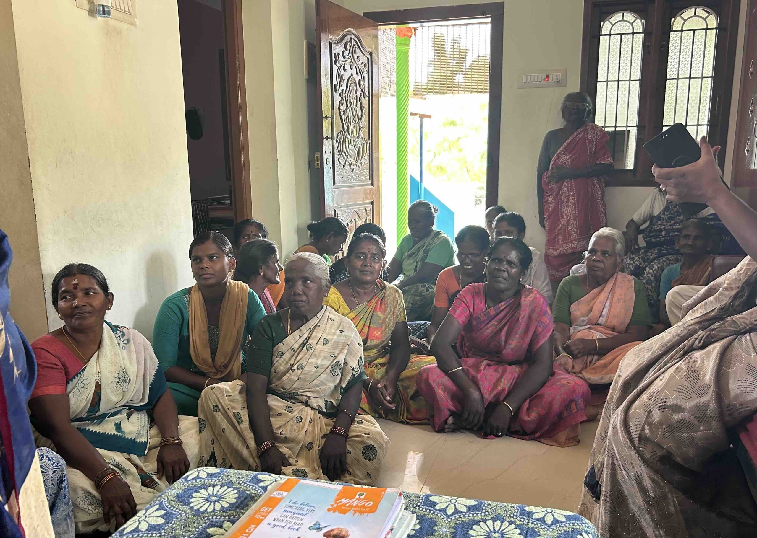 Women sharing ideas and experiences during a microcredit meeting