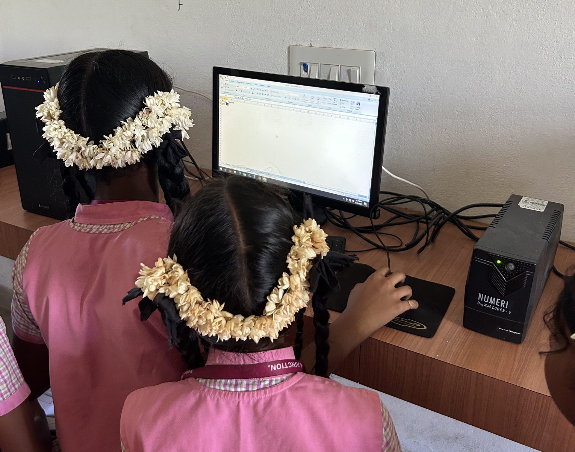 Students working together on a digital assignment in the school lab