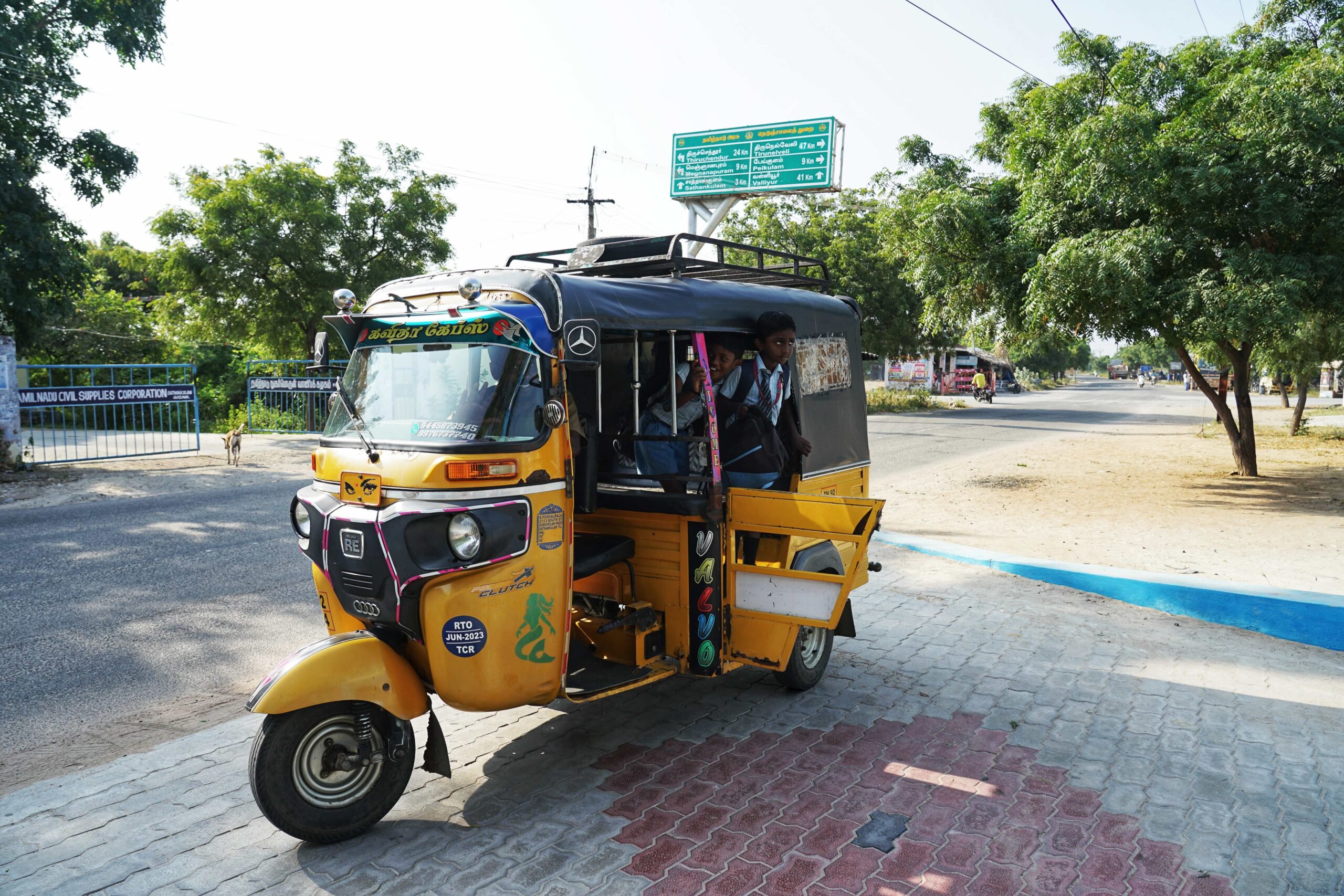 Students getting off an auto-rickshaw at school